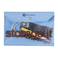 Blue travel organizer with items peeking out on a white background